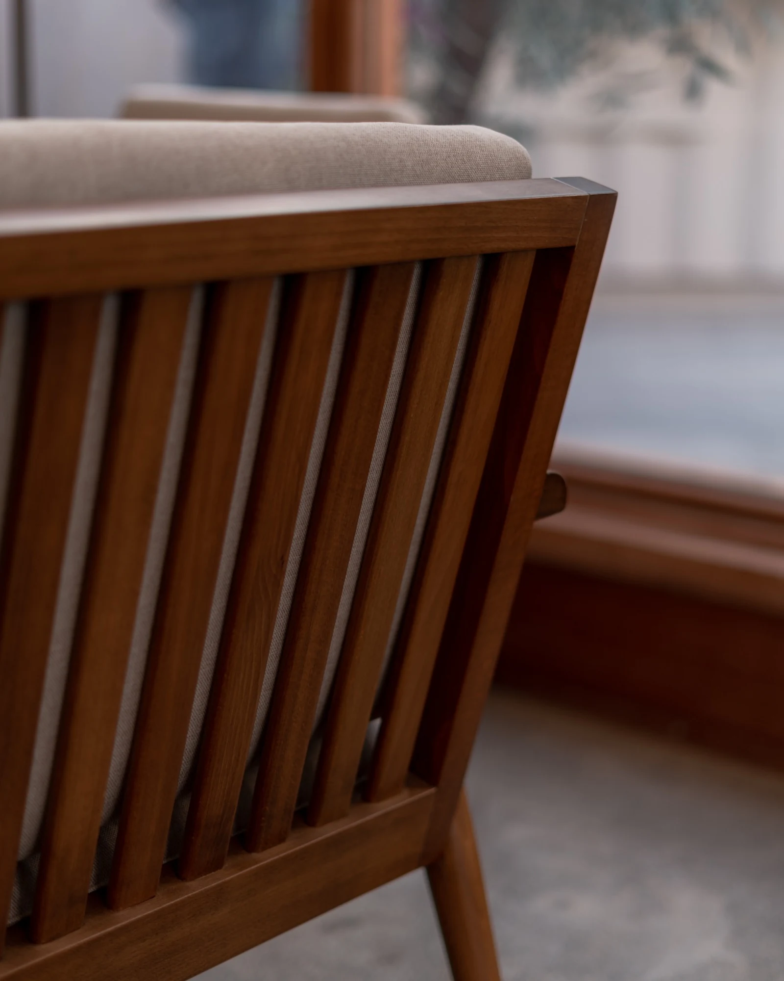 Detail of a timber chair back and upholstered cushion